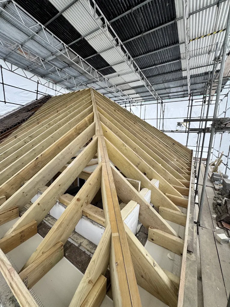 Roof structure timber frame under construction ahead of roof covering
